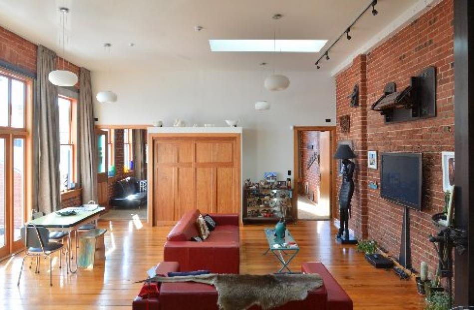 The open-plan living area, with doors at the end leading to a small lounge and a second bedroom.