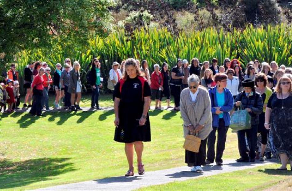 Kaikaranga Vicky Totoro leads a large crowd on to Otakou Marae yesterday. Photos by Craig Baxter.