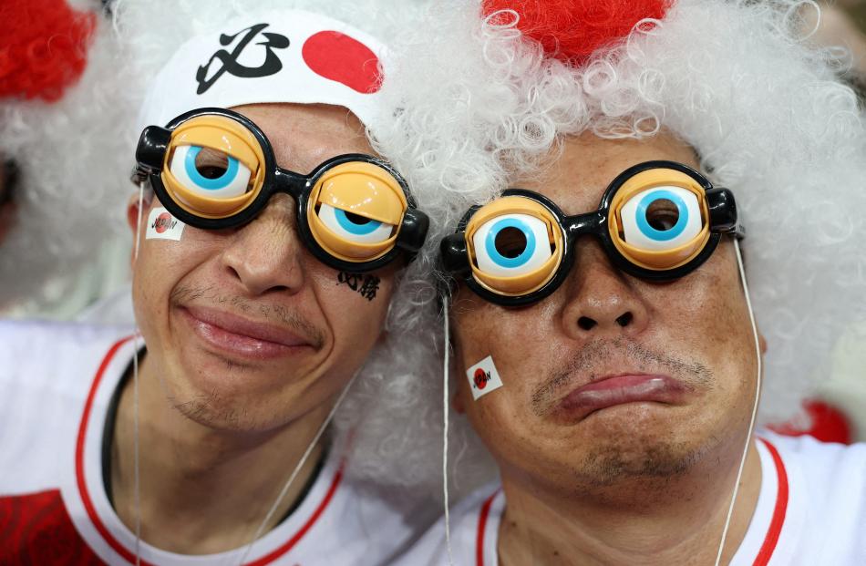 Japan fans ham it up for the camera before their team’s match against England at Allianz Riviera...