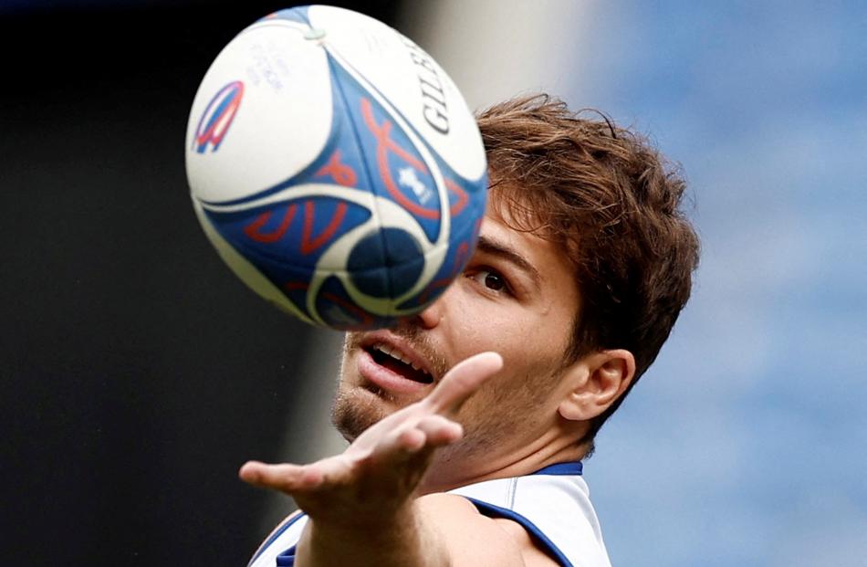France's Antoine Dupont juggles a ball during his team’s training session at Groupama Stadium in...