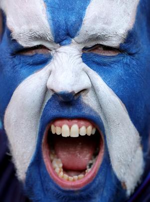 A Scotland fan poses for a photo before his team’s match against Tonga at Stade de Nice on...