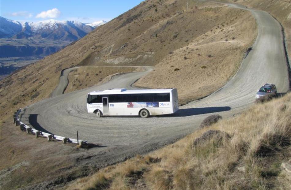 A Remarkables skifield 4WD bus negotiates a twisting section of the access road as it ferries...