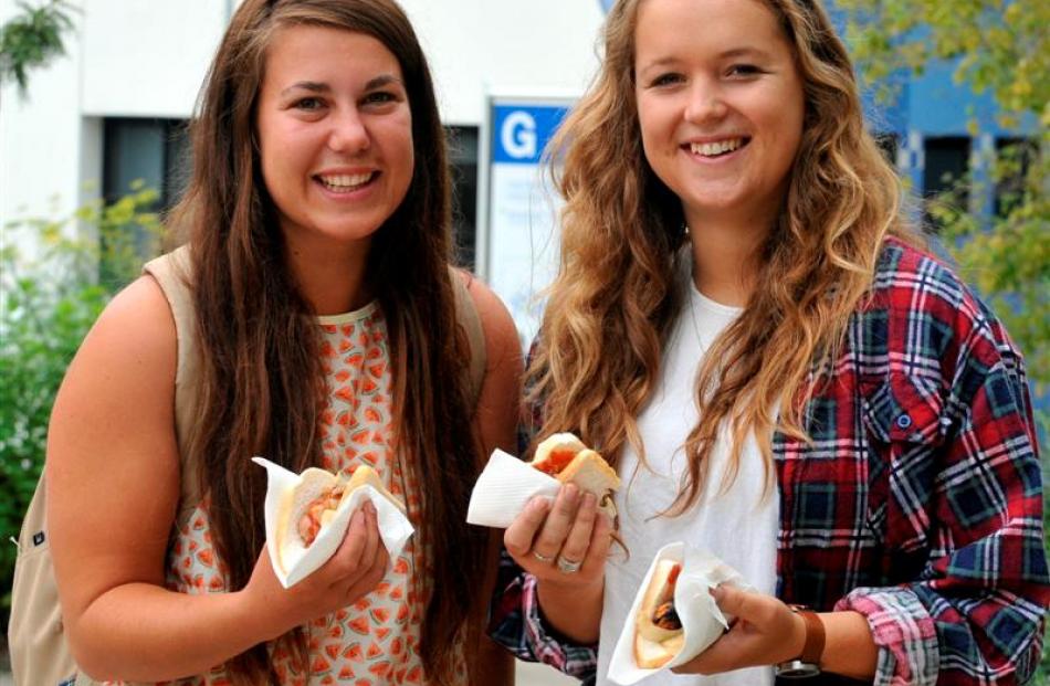 Happy with their free meal are  Paige Spittal (left, 19), of Nelson, and Anae Dixon (19), of...