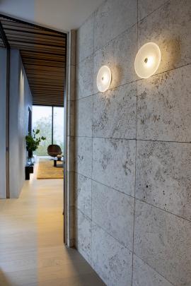 Although brittle and tricky to work with, the unfilled travertine tiles lend a rustic, natural...