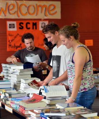Looking at books at the Student Christian Movement (SCM) book exchange yesterday were (from left)...