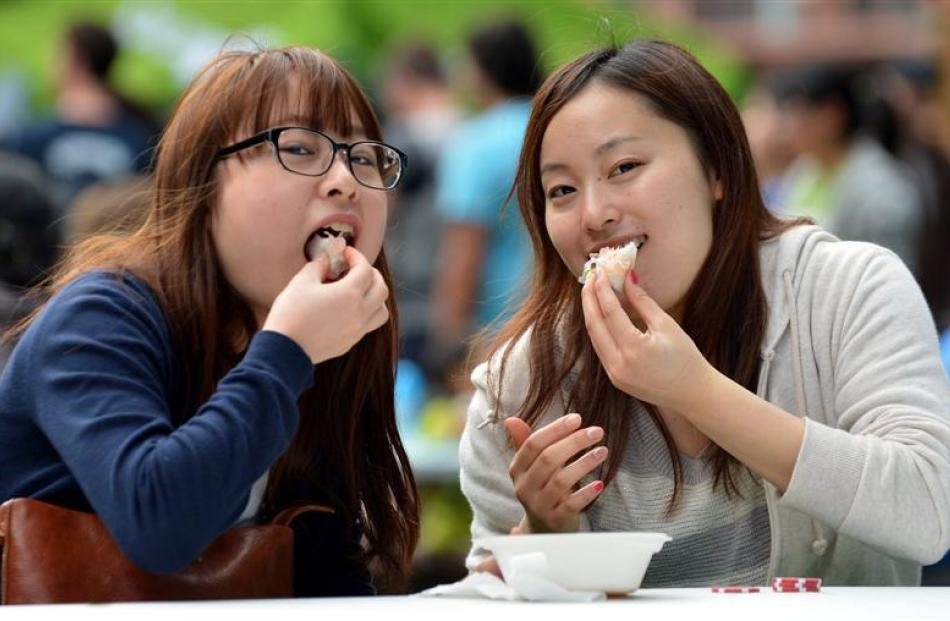 Students enjoying food at the Dunedin International Food Festival on Saturday (from left) Moeka...