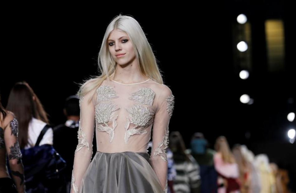 A model presents a creation from Topshop Unique Autumn/Winter 2014 collection during London...