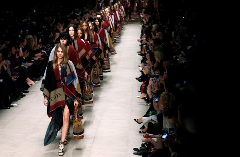 Cara Delevingne leads models as they present creations from the Burberry Prorsum Autumn/Winter...
