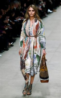 Cara Delevingne presents a creation from the Burberry Prorsum Autumn/Winter 2014 collection...