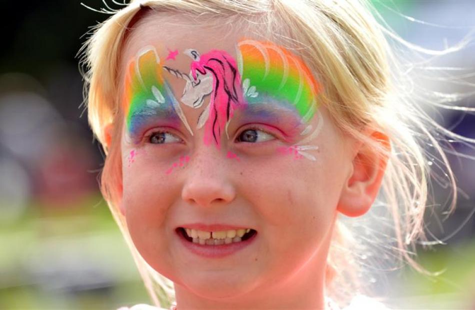 Paige King (6), of Mosgiel, is all smiles after having her face painted at Party in the Park in...