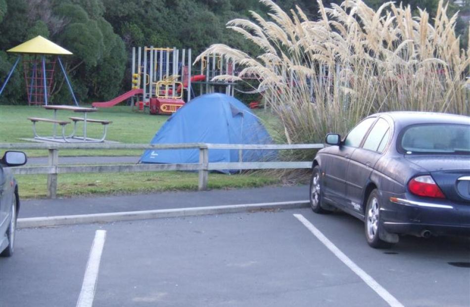 Freedom campers are pitching tents in the Macandrew Bay playground, next to a trial freedom...