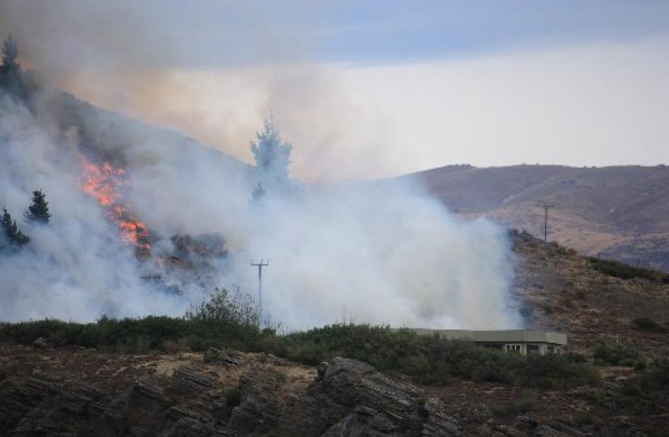 Wind carries the flames away from a Cornish Point house.  Photos by Sarah Marquet and Leith...