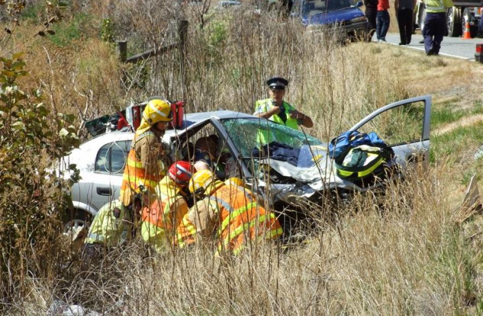 Firefighters work to free a man from the car which left the road. The man was trapped for more...