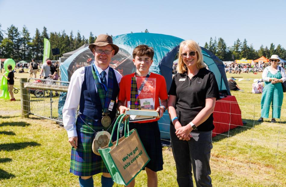 Chieftain Colin Forsyth with Kilted Mile winner Mac Smith and Donna Murry from FMG. Photo:...