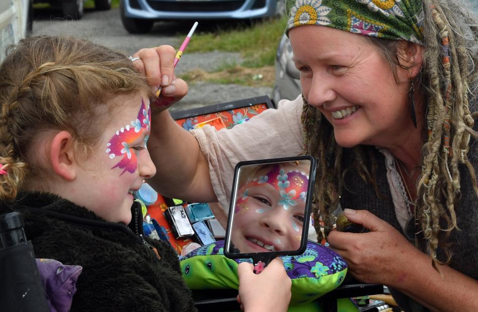 Rebecca Turnball, of Gypsy Room Face Art, applies the finishing touches to Frankie Easton, 7, of...