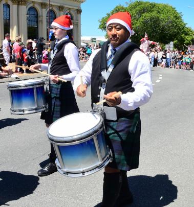 Kane Taualofa keeps in beat with the pipe band.