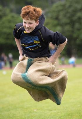 Zander King, 12, moves at speed during the sack race.