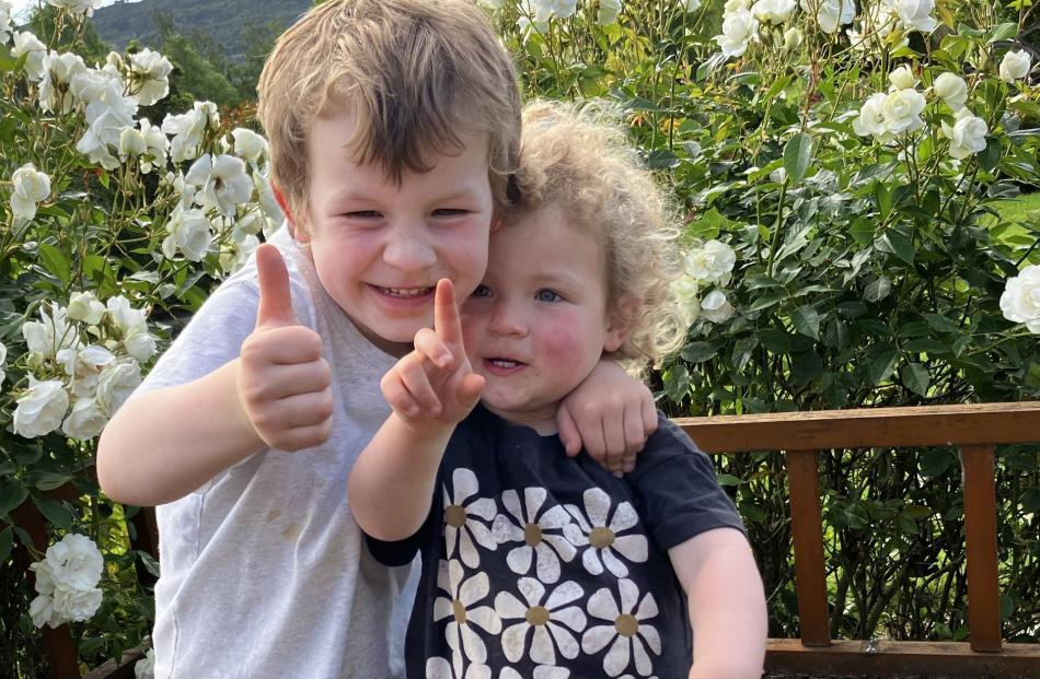 Fingers and thumbs . . . Big brother Ollie Reid, 4, tries to teach his little sister Grace, 2,...