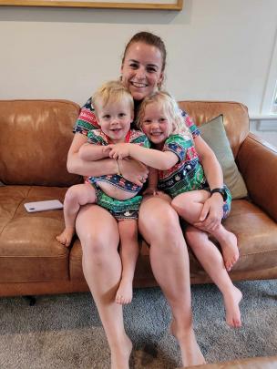 Esther Radford has a cuddle with her nephew Miller Hogdson, 19 months, and niece Olivia Hodgson,...