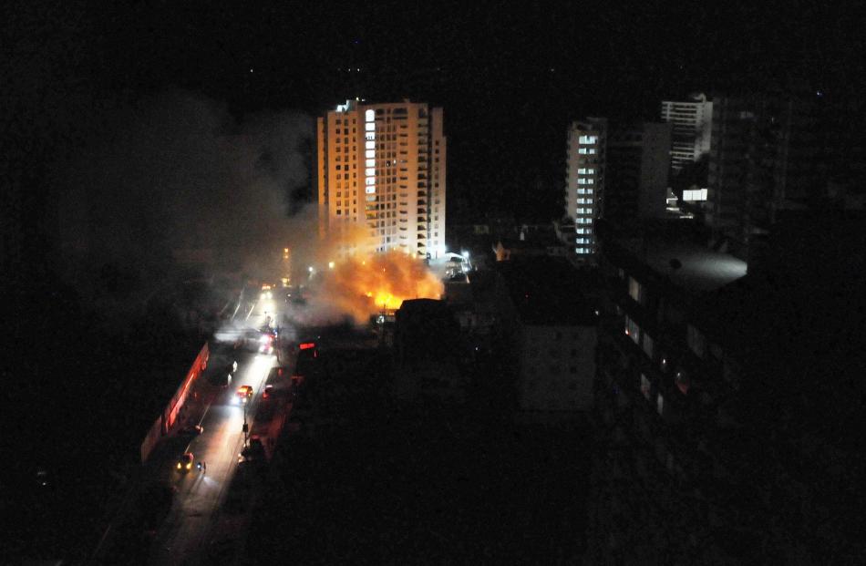 A fire is seen at Iquique city from the top floor of a building during a vertical evacuation...