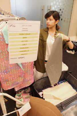 A finalist unpacks her garments to get ready for judging.