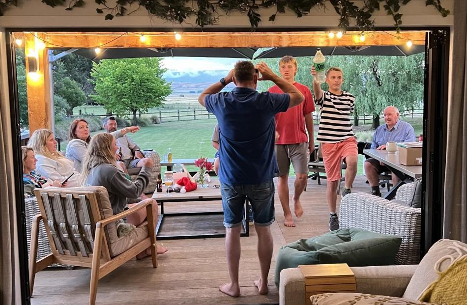 Fun times ... Christmas Day at Poolburn, playing heads-up charades Dan Bilner (back to camera)...