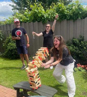 Tumbling down ... Laura Whelan, 23, loses a game of Giant Jenga watched by sister Nicole Whelan,...