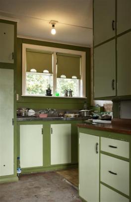 Original  cabinets in the kitchen. The tall cupboard houses the hot-water cylinder.