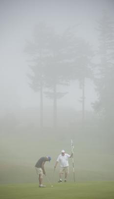 Thick fog did not deter Ian Pillans (left) and Robin Hyndman from a round at the Otago Golf Club...