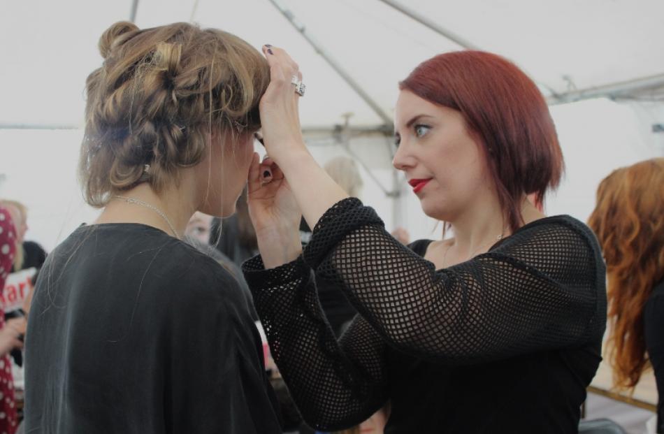 Katy Parsons from Ali McD Make-up and Modelling prepares a model for the runway.