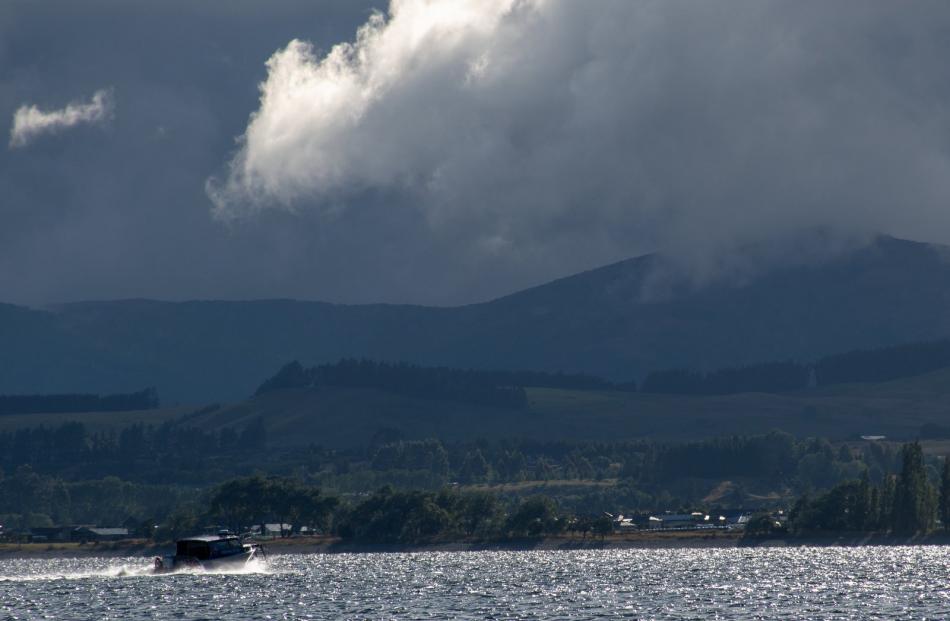 Making haste . . .  A water taxi returns from Brod Bay back to Te Anau under a threatening sky on...