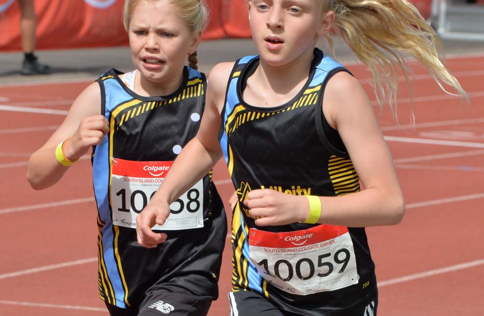 Leila Kindiak (Hill City University) leads her team-mate, Penelope Hodgson, in a girls grade 10...