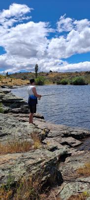 Are they biting? Lucas Gibson, 16, goes fishing on New Year’s Eve at Conroys Dam, Central Otago....