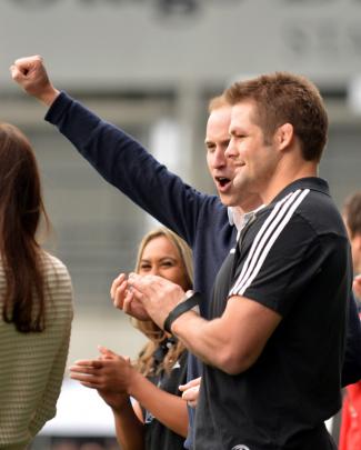 Prince William celebrates a try from his Rippa Rugby team while watched by McCaw.