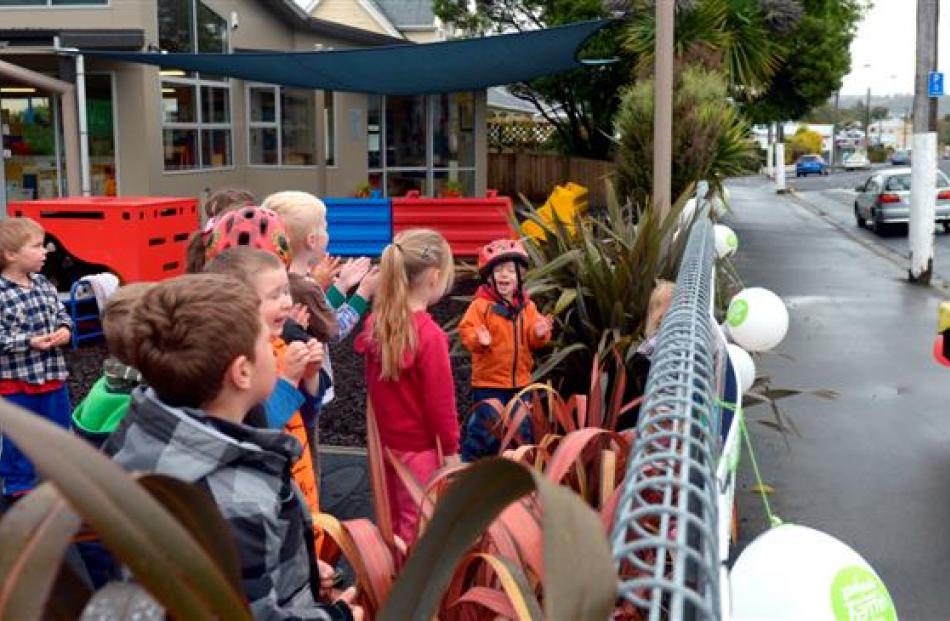 Children from Jonathan Rhodes Kindergarten, in North Rd, greet him on his round.