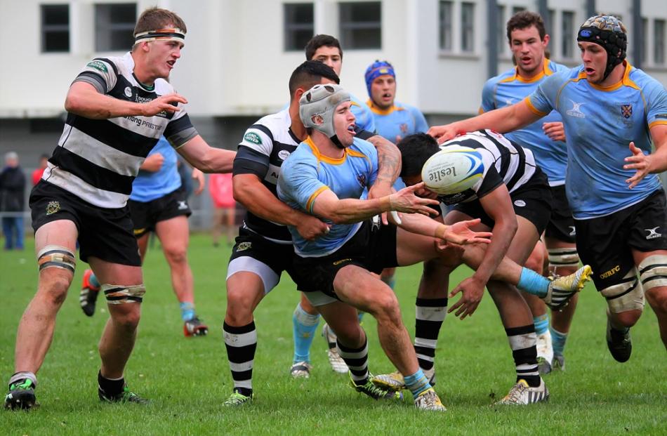 University A First Five Fletcher Smith manages to get his pass away in the tackle of Southern...