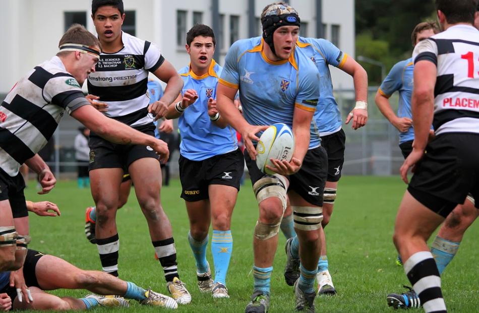 University A flanker Jack Wolfreys looks to get the ball alive after taking a pass from team mate...