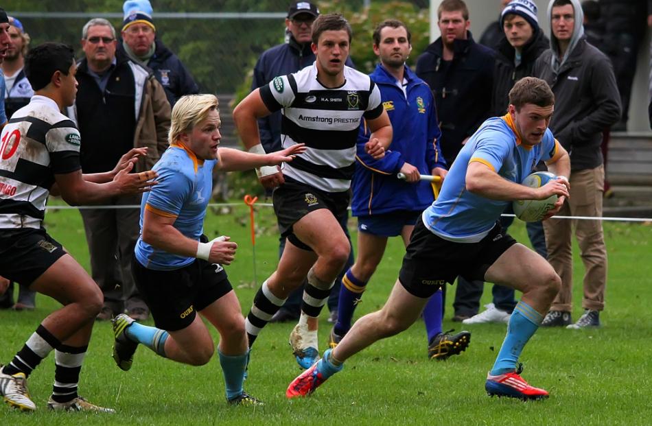 University winger Gavin Stark steps his way through several Southern tacklers.