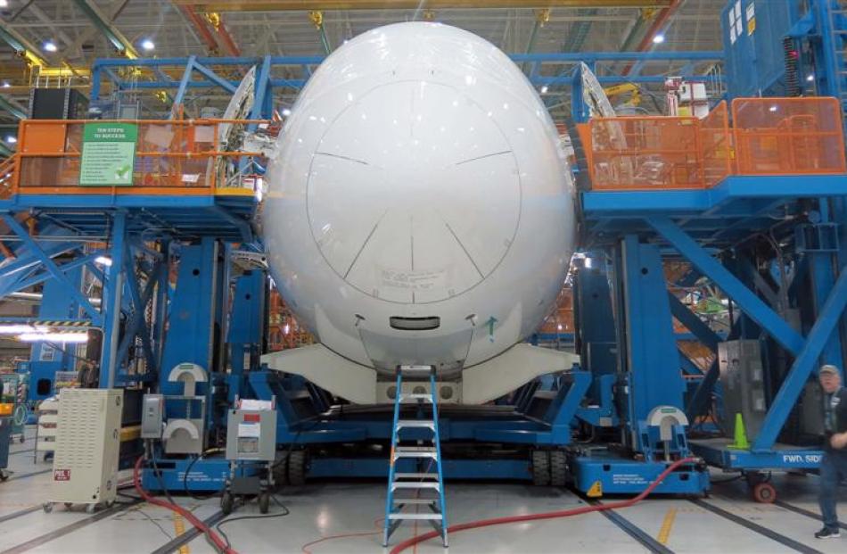 Teams of engineers work in their mobile ''office'' on the Dreamliner production line. Photo by...