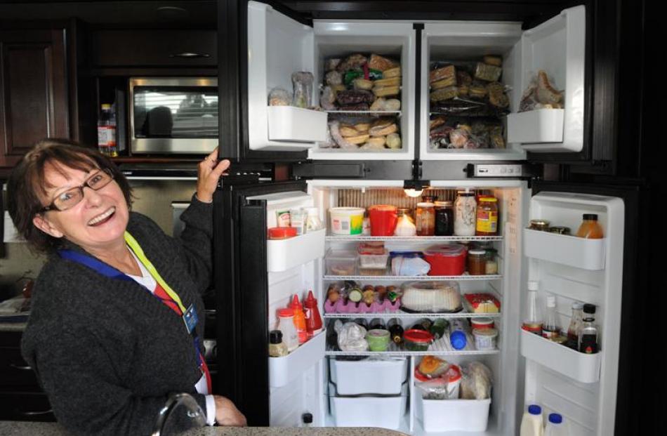 Mrs Johnson checks  the well-stocked fridge and freezer.
