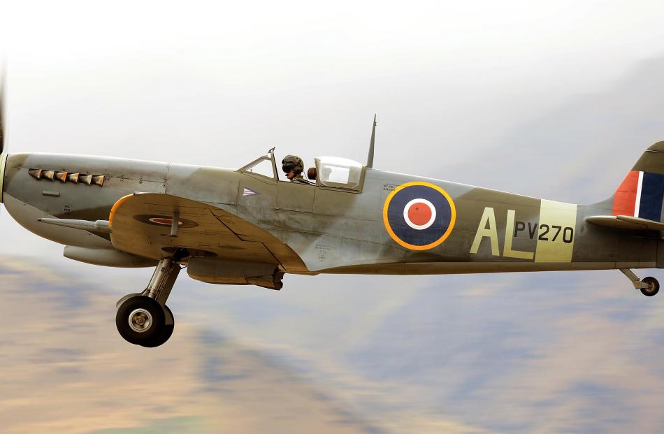Sean Perrett has the canopy open as he brings a Supermarine Spitfire in to land.