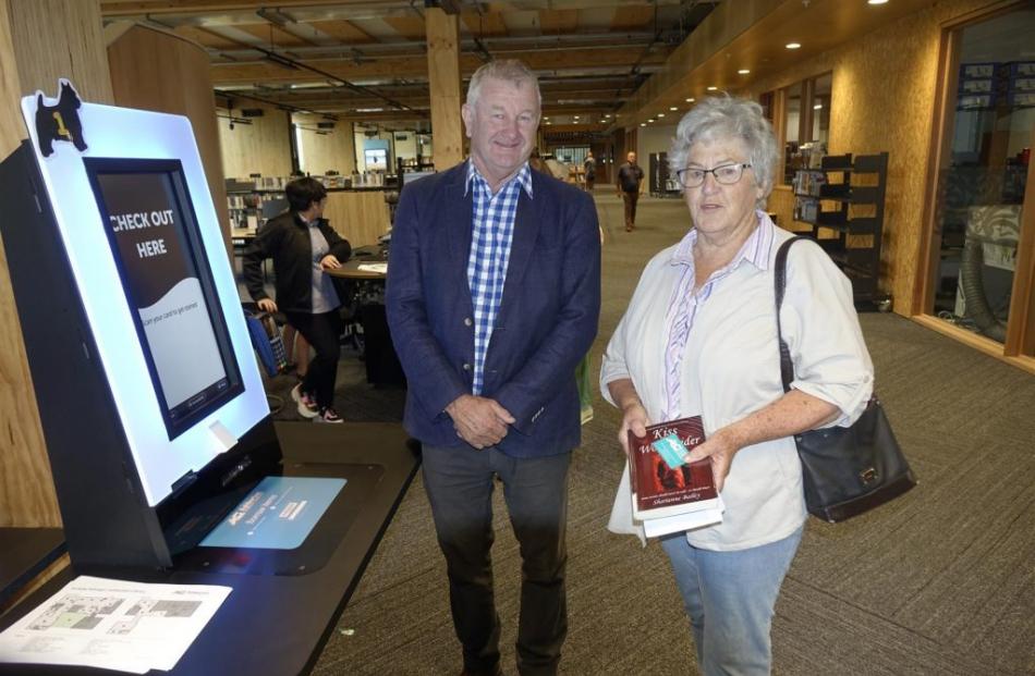 The first library visitor to borrow books, Jeni Wiggins, with mayor Neil Brown. Photos: Supplied