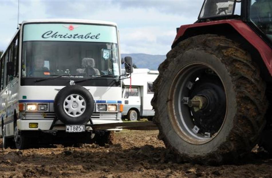 Motorhomes are towed out of the Taieri A&P Showgrounds  on Monday  after becoming bogged down in...