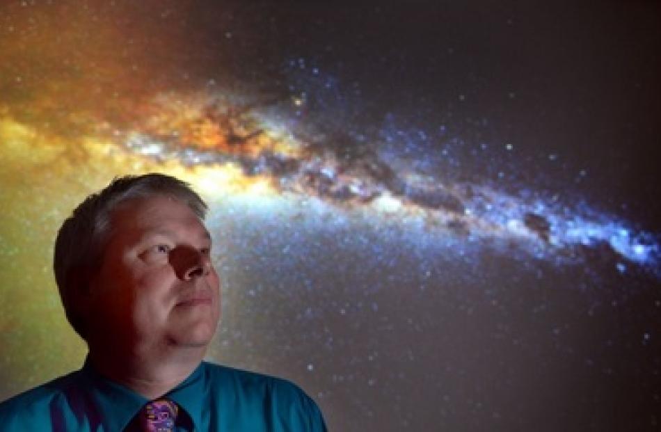 Otago Museum director Dr Ian Griffin with a photo he took of the Milky Way from Otago Peninsula...