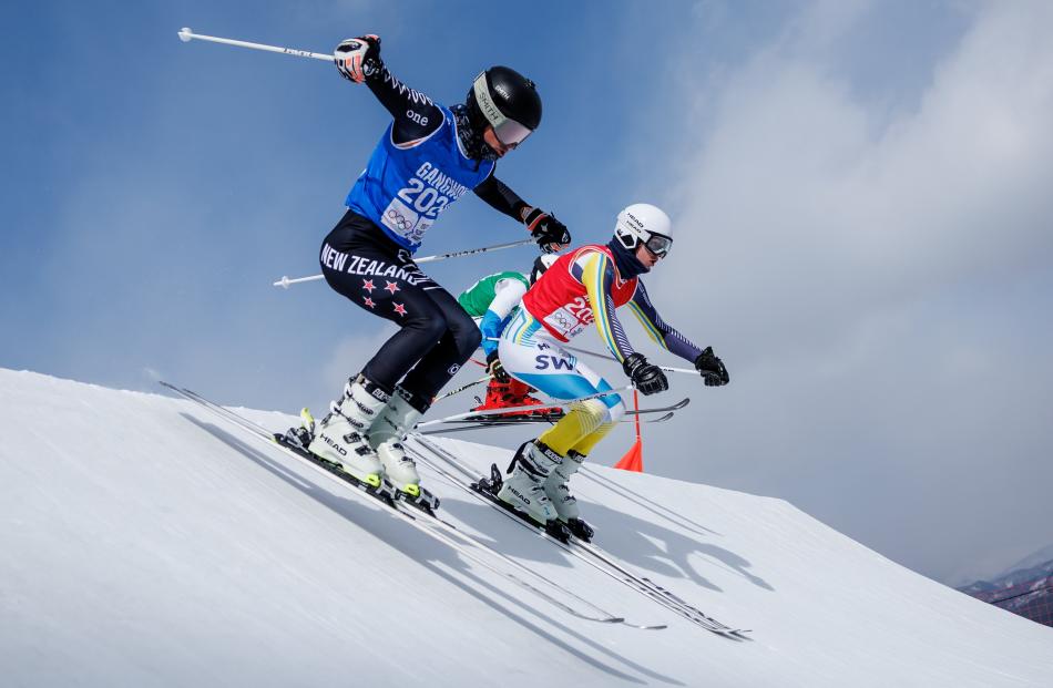 Wānaka skier Campbell Appel, left, competing in the Freestyle Skiing Men’s Ski Cross group heats. 