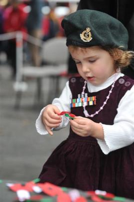 Two-year-old Isla Atkinson, of Dunedin, wears her mother's New Zealand Army beret and her father...