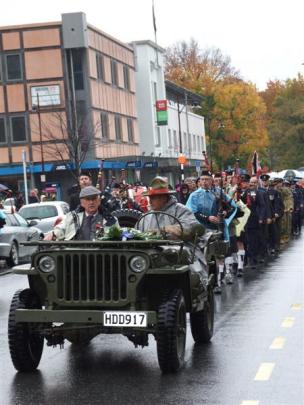 The parade winds its way along Camp St during its journey from the Memorial Gates at Queenstown...