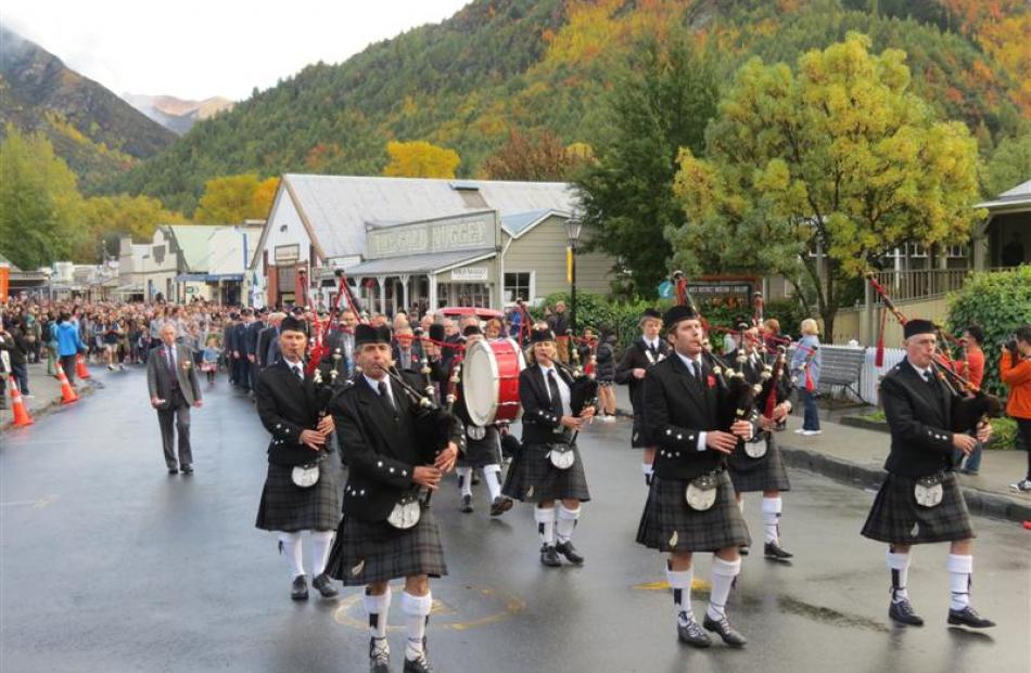 The Queenstown and Southern Lakes Highland Pipe Band lead the parade of Anzac Day supporters from...