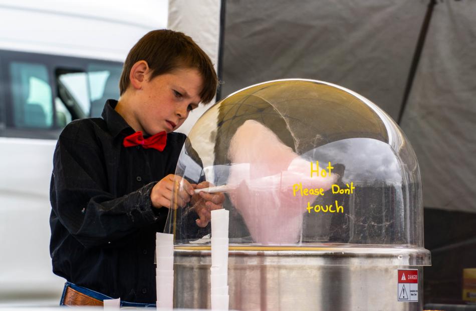 Axel McLeod, 10, spins cotton candy for sweet-toothed customers.