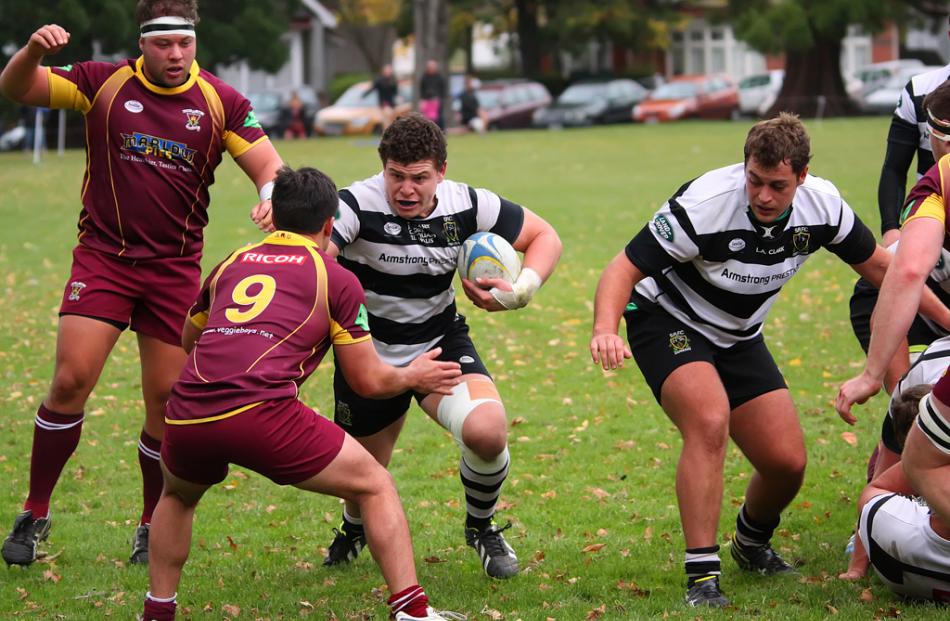Southern hooker Ricky Riccitelli drives his way into Alhambra Union halfback Caleb Gray. Photo by...